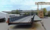 Part of a metal ship structure at a shipyard, prepared for further assembly.