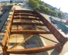 Aerial view of a large rust-colored steel frame structure at an industrial site.