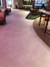A view of a modern lounge area with comfortable seating and a bar.