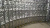 Curved metal framework installed against a wall lined with reflective insulation, awaiting further construction work.
