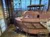 Partially constructed ship in a shipyard.