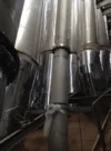 View of large industrial metal pipes, part of a ventilation inside a facility.