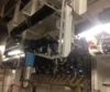 Interior view of an industrial facility with various pipes, valves, and machinery components, showing a complex network of equipment.