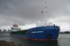 Cargo ship 'Johanna Desiree' docked at port under a cloudy sky.